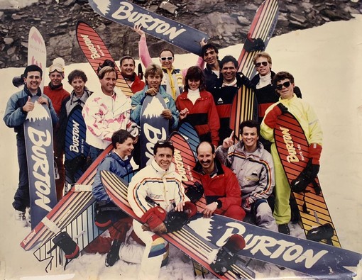 Jake Burton, Angelo Zambito e il team di rivenditori europei al 1° meeting degli importatori in Austria nell'estate del 1986 Jake Burton, Angelo Zambito e il team di rivenditori europei al 1° meeting degli importatori in Austria nell'estate del 1986