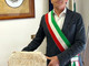 Nell’immagine, il Sindaco di Pizzoli Giovannino Anastasio con la pietra consegnata a Biella